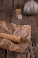 Wafer roll with boiled condensed milk on a wooden table