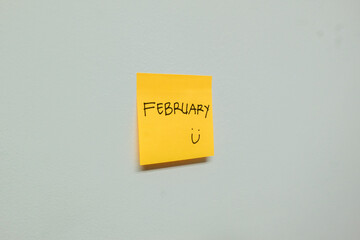 February sign on a sticky note.