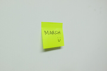 March sign on a sticky note.