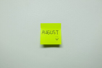 August sign on a sticky note.