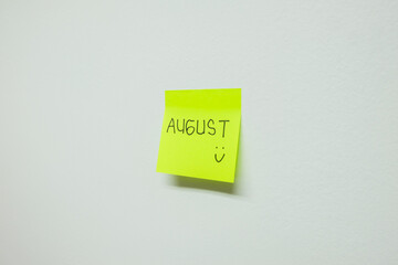 August sign on a sticky note.