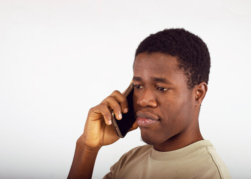 A young man using a smartphone. Ideal for themes of communication, technology, and modern lifestyle.