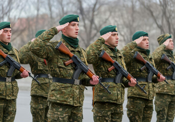 Bulgarian soldiers giving salute during ceremony military, glory and honor, dignified military uniform