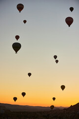 Fototapeta premium Balloons lifted into the air in Cappadocia. Entertainment and tourist attraction. A spectacular sight
