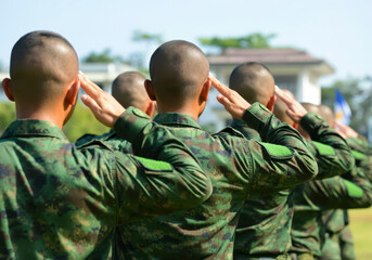 Filipino soldiers giving salute during ceremony military, glory and honor, dignified military uniform