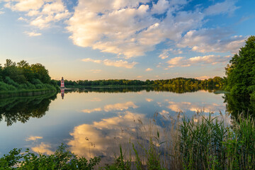 Moritzburg Castle lighthouse at sunset. Sunset clouds reflected in lake. Photowallpaper. Near Dresden in Saxony, Germany