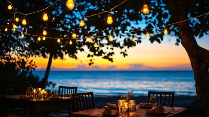 Fototapeta premium A cozy outdoor dining scene at sunset, featuring beautifully arranged tables with ambient lighting, surrounded by lush trees and serene ocean views.