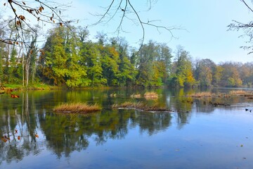 Krka river at Otočec in Dolenjska, Slovenia with autumn colored trees on the shore