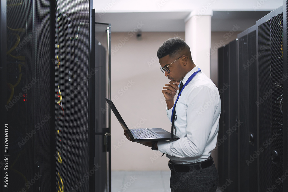 Poster black man, technician and thinking with laptop in server room for software, hardware or network repa