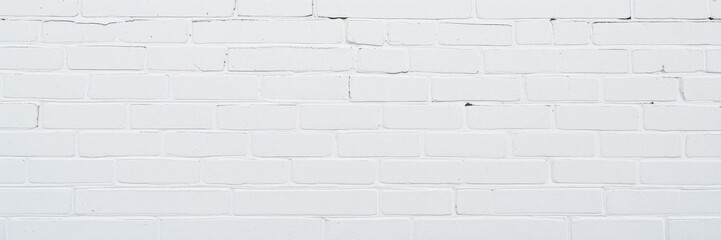 Fototapeta premium A close-up shot of a white brick wall with a rough texture perfect for backgrounds, vintage, surface, architecture