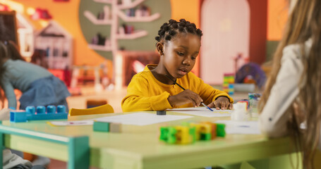 Portrait of an Adorable Stylish Black Girl Using Watercolor to Draw a Colorful Painting. Cheerful African Child Spending Productive Time in Preschool, Learning to Paint in Art Class