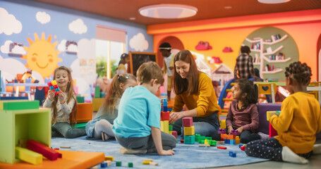 Cheerful Diverse Kids Playing with Colorful Building Block Toys in Kindergarten. Group of...