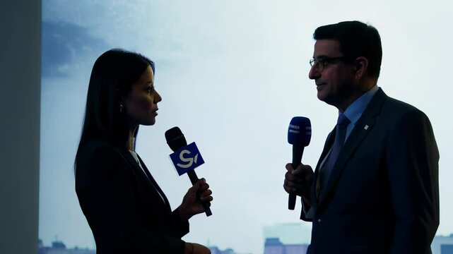Silhouetted journalists interviewing each other with microphones, creating a dramatic, backlit scene that highlights media exchange and professional communication