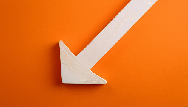 White wooden arrow pointing down on orange background. Business, market decline or economic.