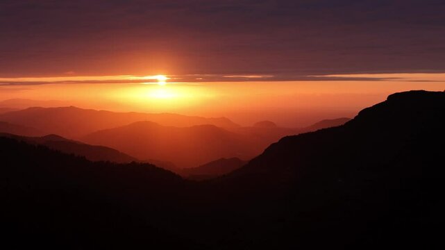Aerial footage of the sunset at the sea from the basque mountains.