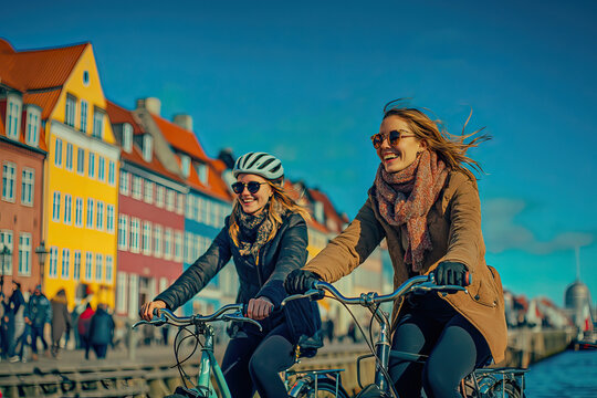Two friends riding bikes along the Copenhagen canal