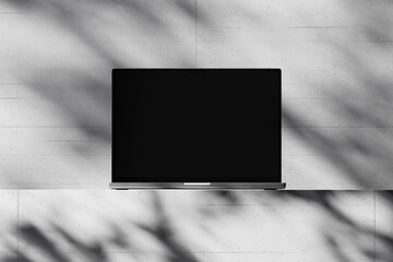 Scene with an open laptop with a blank screen on a concrete background