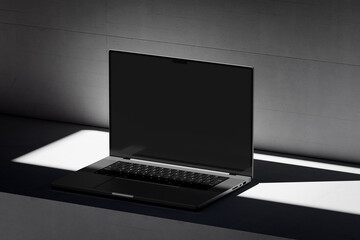 Scene with an open laptop with a blank screen on a concrete background