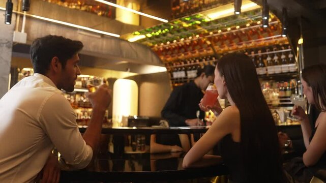 Couple making a toast with cocktail paloma and old fashioned at luxurious bar in lively conversation drinks celebrating a special party at vibrant nightclub while friend drinking Margarita. Vinosity.