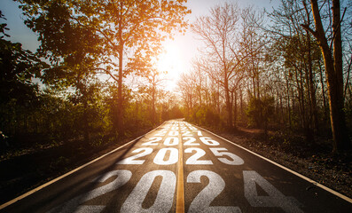 2024-2030 written on highway road in the middle of empty asphalt road and beautiful blue sky....