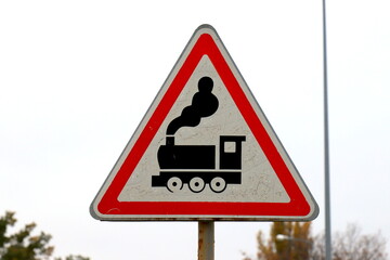 Triangular road sign approaching railway crossing without a barrier. Warning road sign railway crossing