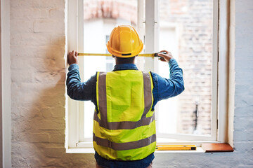 Engineer, man and measuring tape on window for construction, renovation and maintenance with back...