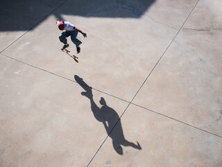 Skateboarder performing a mid-air trick on a sunny day
