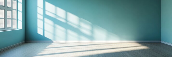 Obraz premium 明るい青色の壁の部屋に差し込む光の影と木製の床のコントラスト