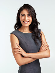 Fototapeta premium Professional, studio and confident portrait of woman with ambition, business and real estate agent. Consultant, realtor or businesswoman with pride, opportunity and arms crossed on white background