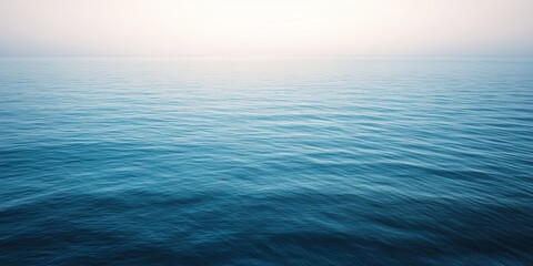 Fototapeta premium 静かな海の景色、穏やかな波が広がる青い水面、朝の光が差し込む