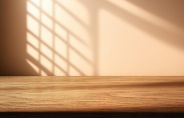 Empty wooden tabletop and a wall with beautiful shadows from the window in the background.