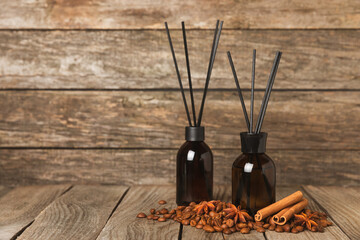 Aromatic reed air freshener on wooden table.Diffuser with natural fruity, floral, spicy aroma.interior scent. Luxury perfume for the home.Orange, lime, coffee, cinnamon, star anise, vanilla and orchid