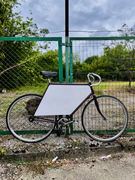 Bicycle standing by a gate