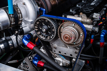 Fototapeta premium Twin cam engine car with pully wheels and cam belt.The pulley is precision crafted from aluminum and provides precise alignment for perfect engine performance.