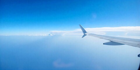 Obraz premium the wing of an airplane with the blue sky in the background