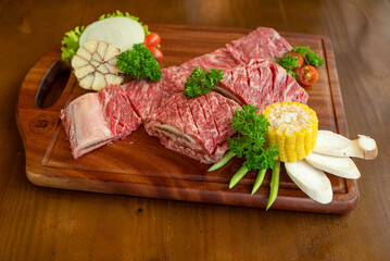 raw meat with vegetables on the wooden board