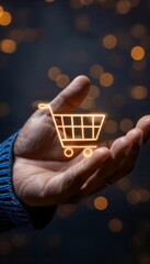 photo of a man's hand holding a shopping cart icon, symbolizing consumer society, online shopping