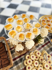 An assortment of desserts, sweets, and pastries adorns the holiday buffet table. Vertical image.