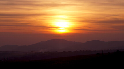 Red sunset on the mountain background