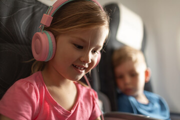 Happy children flying on airplane family travel holiday concept 