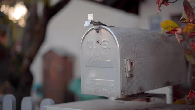 Mailbox outside private house in autumn in Germany, Bavaria city of Munich. Briefkasten in Bayern, Deutschland. Antique postkasten in Munchen. Letterbox in Muenchen. Vintage postbox in private home. 