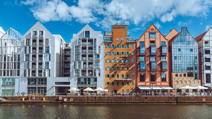 Modern and historic buildings standing on the motlawa river in gdansk, poland