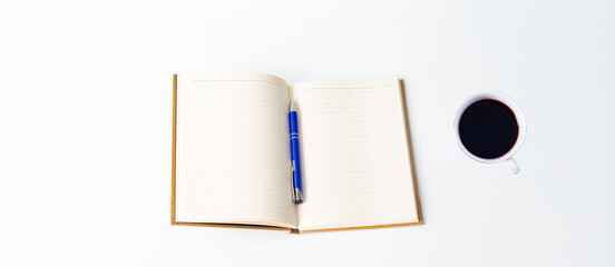 Desk idea concept, open notebook, pen and mug of coffee isolated on white background or table. Journaling, study. Top view