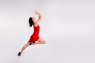 Full length photo of sensual tempting lady dressed red sexy outfit enjoying dancing bachata empty...