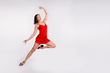 Full length photo of stunning adorable lady dressed sexy red outfit enjoying ballet dance class empty space isolated white color background © deagreez