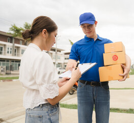 Delivery Confirmation: Woman signing for a package from a friendly delivery driver.  A seamless and...