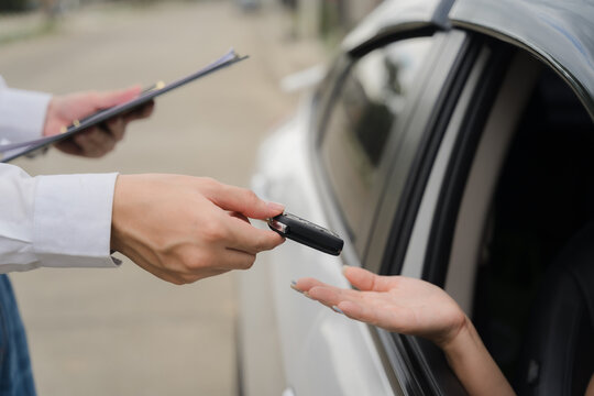 Car Key Handoff: A close-up shot of a car key being exchanged between two people, symbolizing a moment of transaction and new beginnings. The image evokes a sense of trust, excitement.