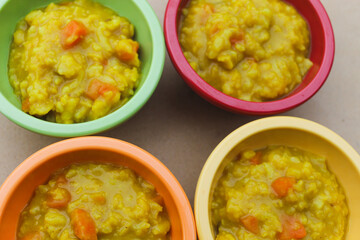 macro close-up of Dal kitchari Indian rice meal in colorful bowls hearty nutritious background