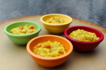Dal kitchari Indian one pot meal in colorful bowls nutritious background