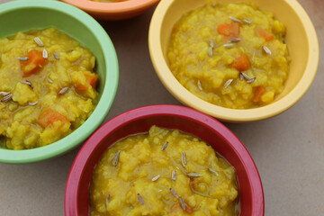 Colorful close-up Dal kitchari Indian one pot meal in small bowls nutritious background